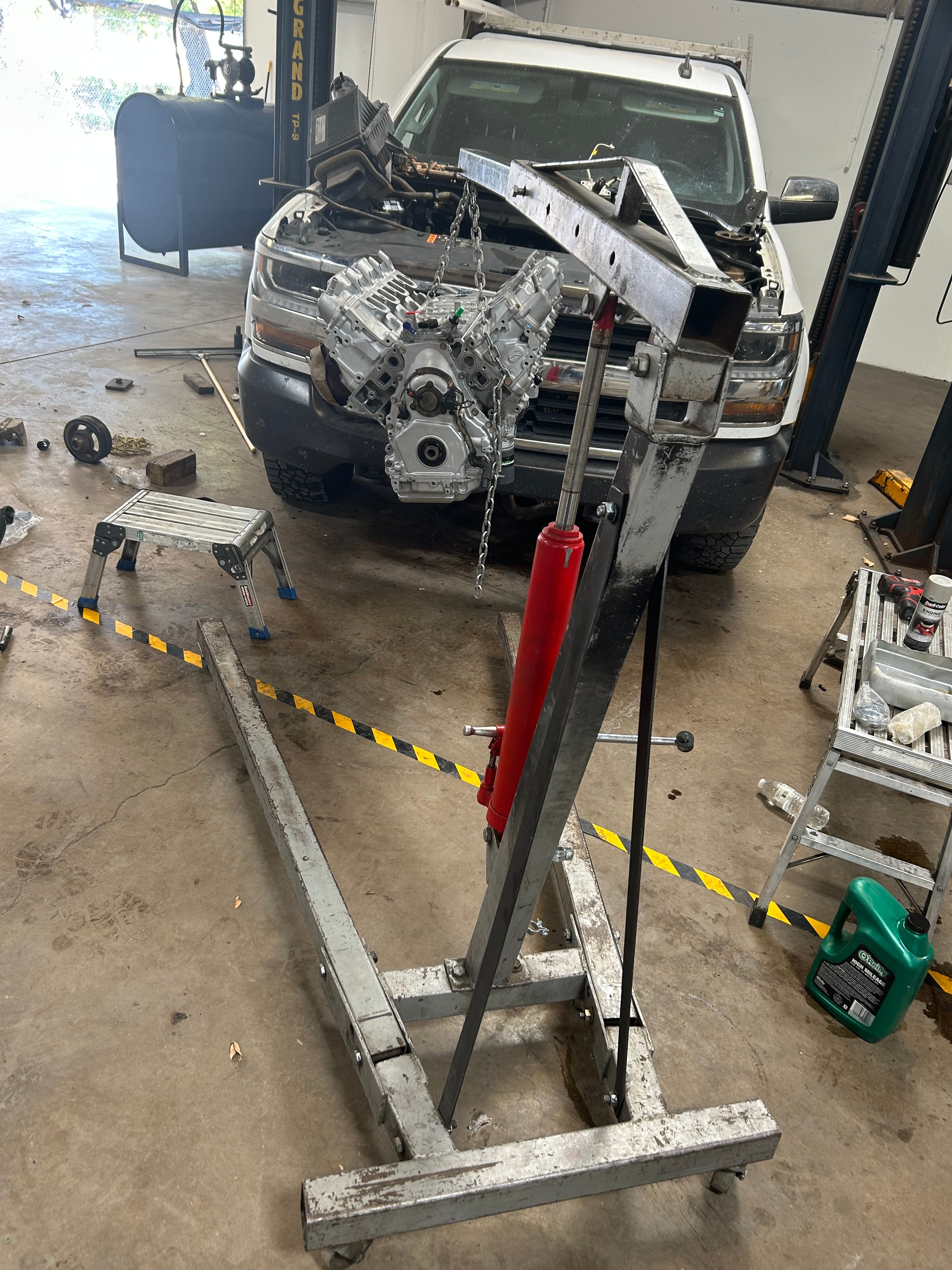 Engine being pulled from a truck with a hoist at Five Star Engine Rebuilders